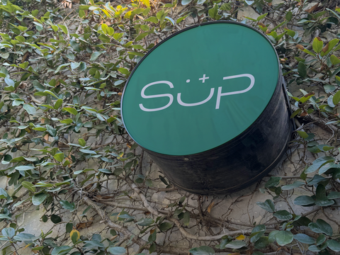 Round store sign PSD Mockup on green wall